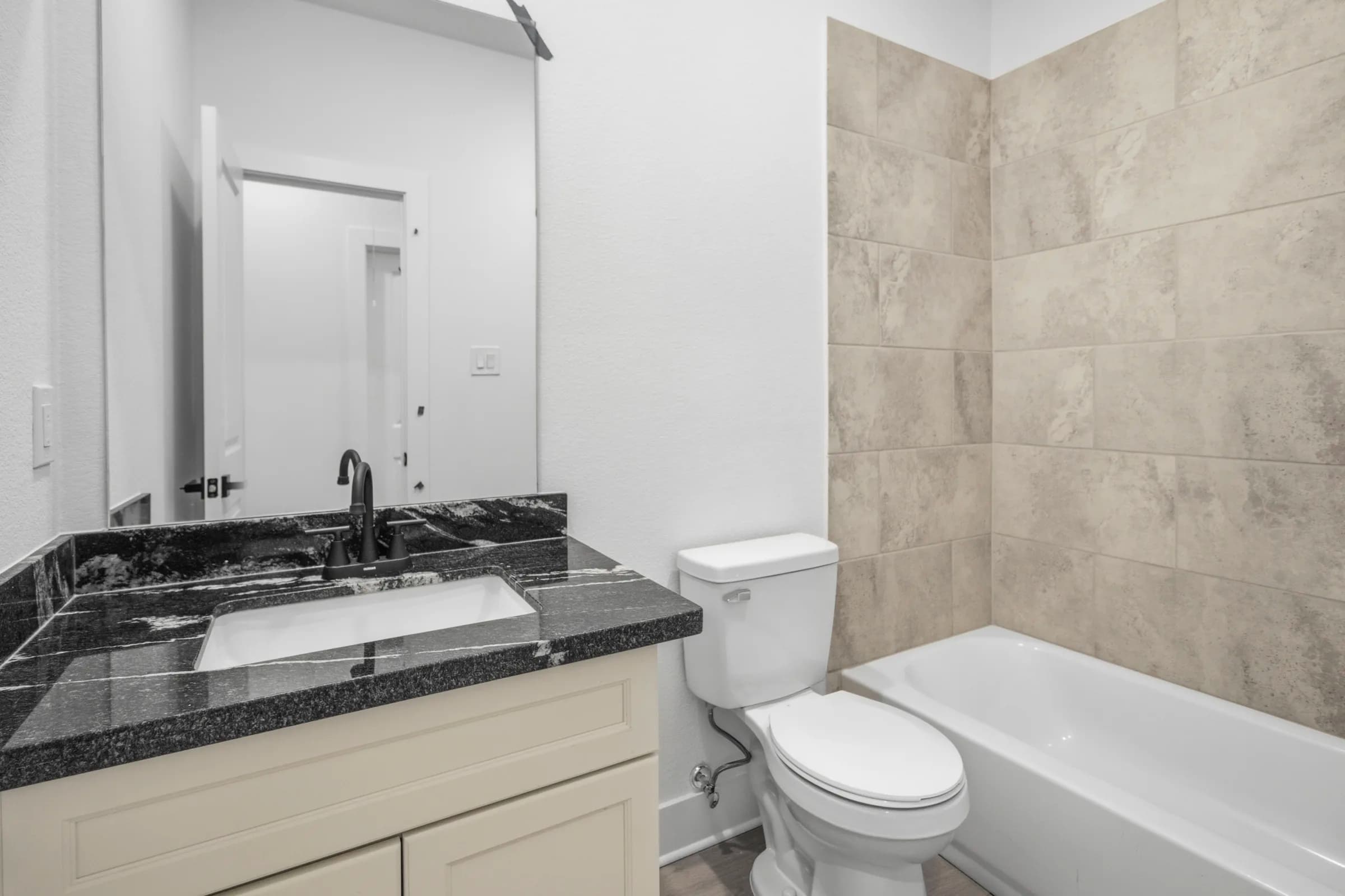 Full bath with tub and granite vanity