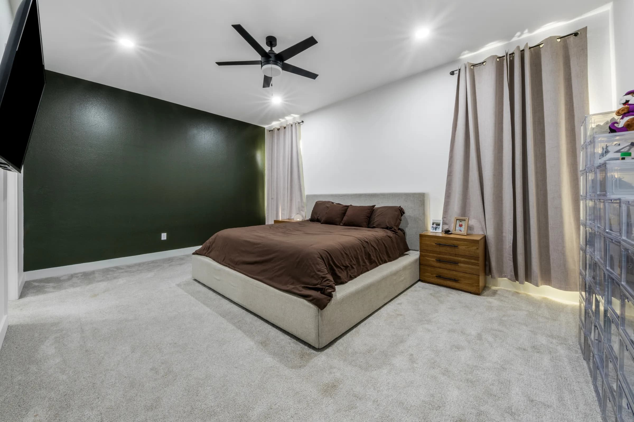 Primary bedroom with green accent wall